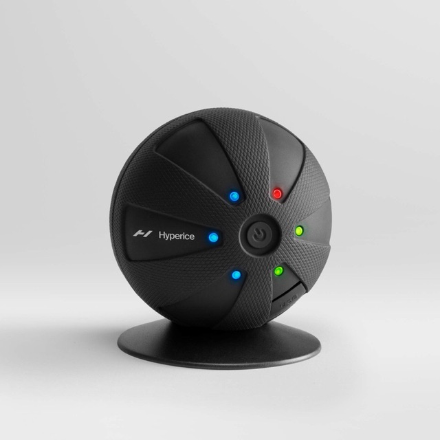The Hypersphere vibrating massage ball on its stand